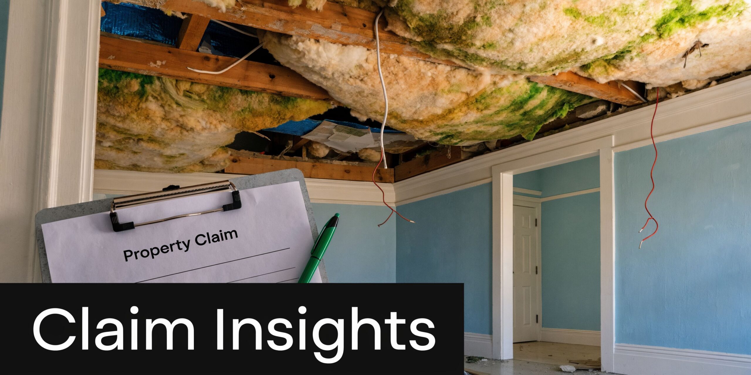 A clipboard with a property claim form held in front of a damaged ceiling with exposed insulation.