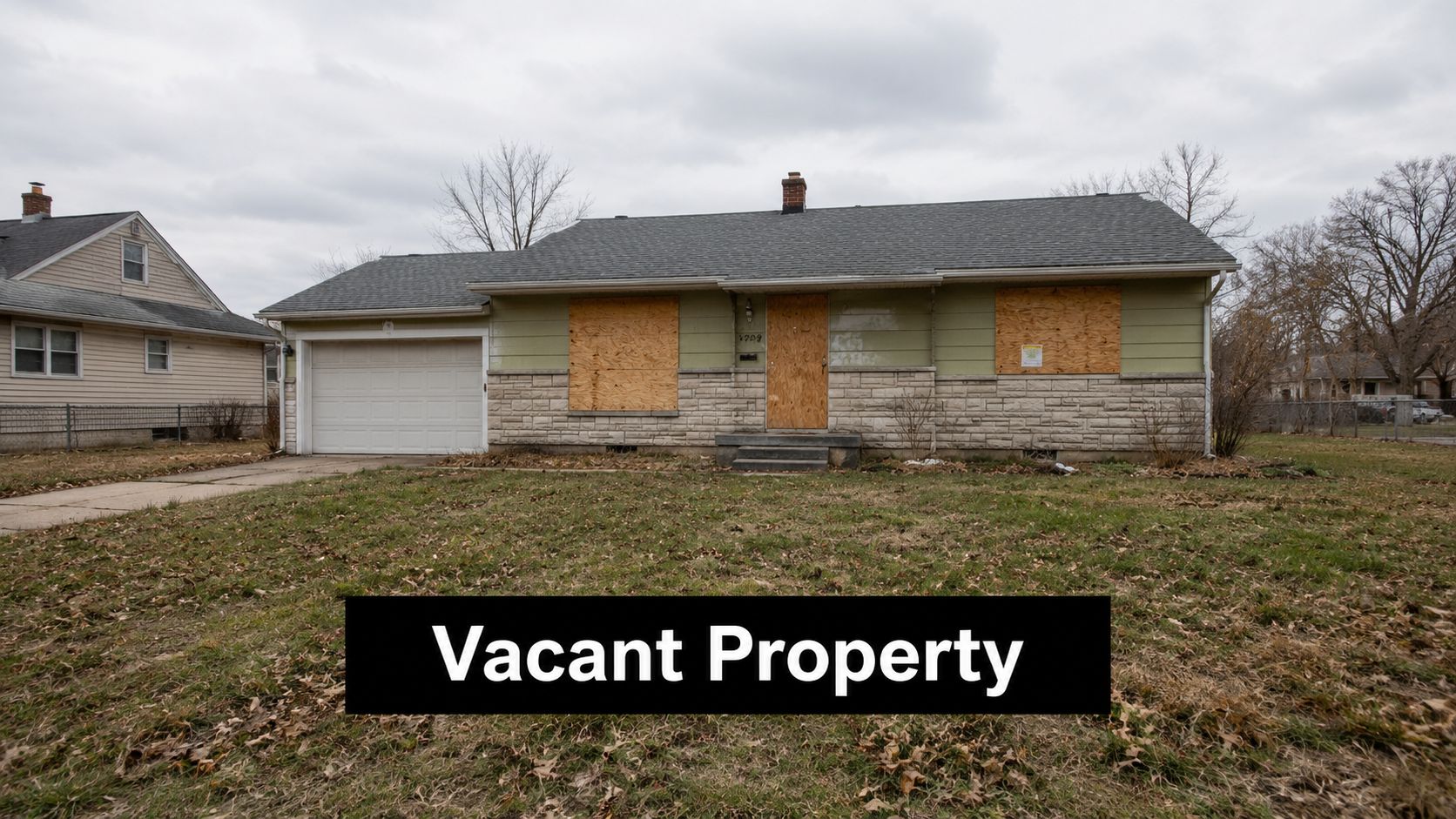 A single-story vacant residential house with boarded up windows and doors in a suburban neighborhood.